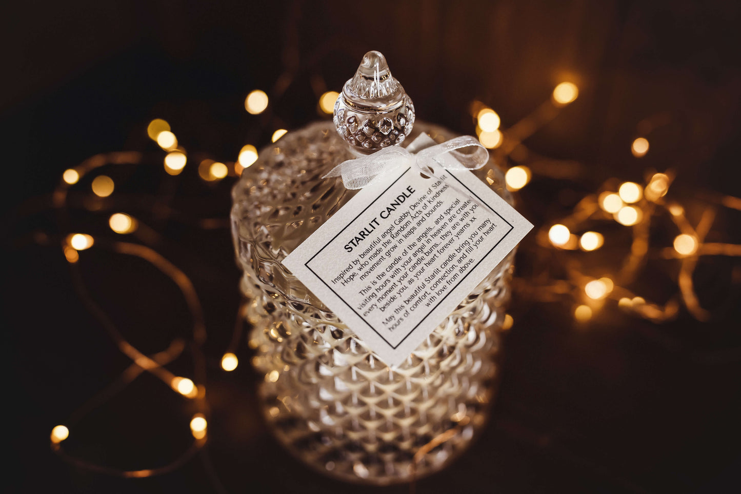 The Starlit candle with the swingtag that accompanies each scented candle. The vessel can be used to keep cherished items once the candle has reached the end of its journey.